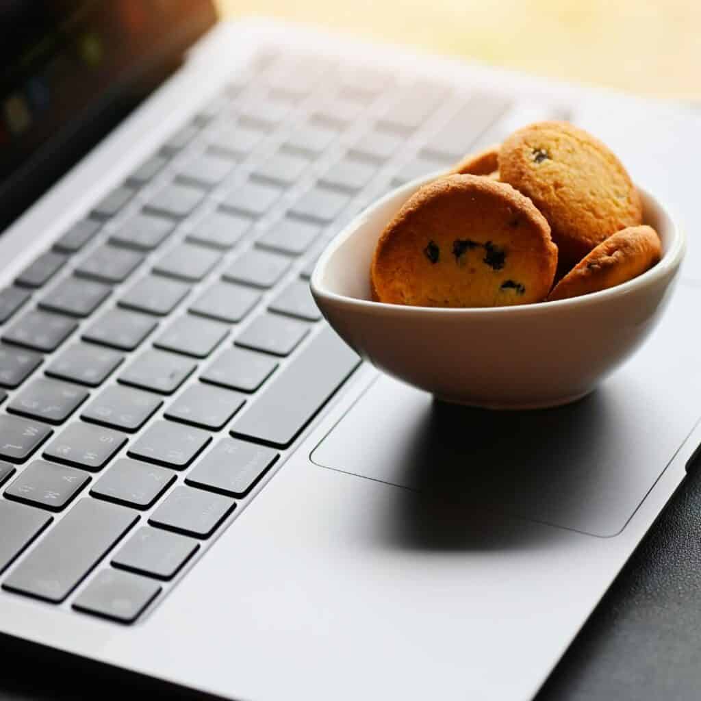 Image of cookies on a laptop to illustrate how to set up a cookie consent plugin for WordPress

